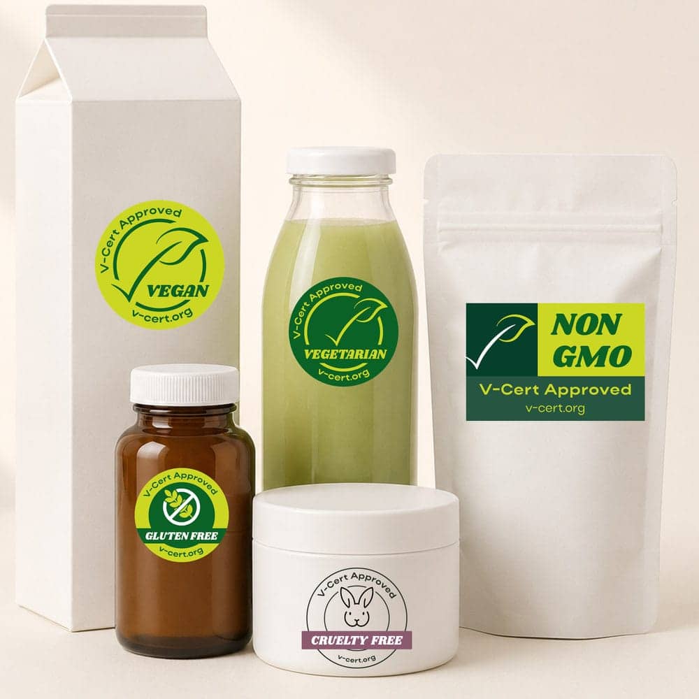 Five unbranded retail packages grouped on a warm cream background in bright daylight, each carrying one V-Cert mark: Vegan on a carton, Vegetarian on a bottle of green juice, Gluten-Free on an amber supplement bottle, Non-GMO on a stand-up pouch and Cruelty-Free on a cosmetic jar.